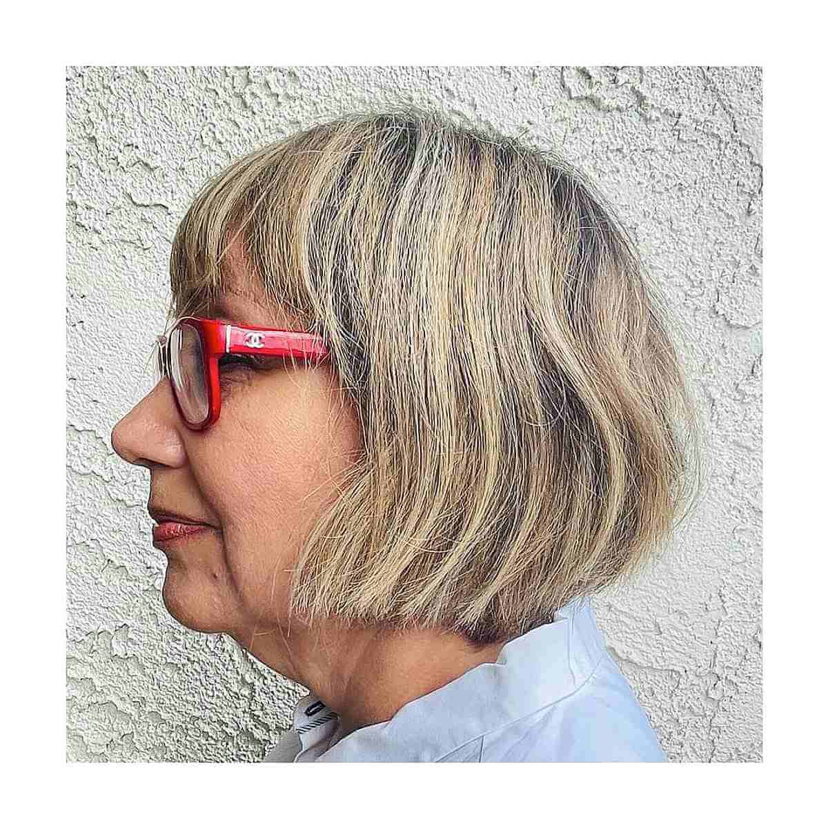 face framing short haircut with bangs and glasses for 60 year olds