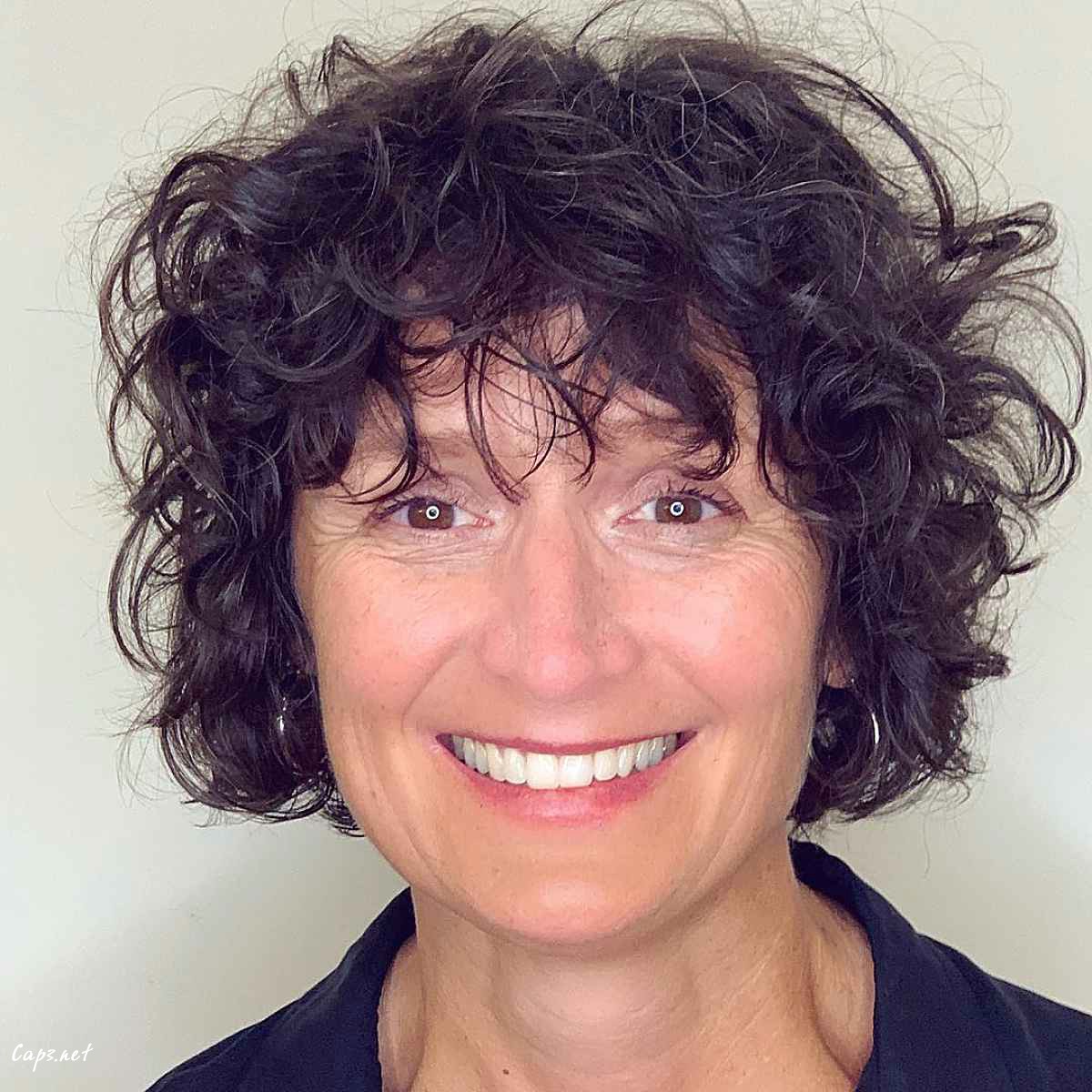 short curly bob haircut with fringe for 60 plus women