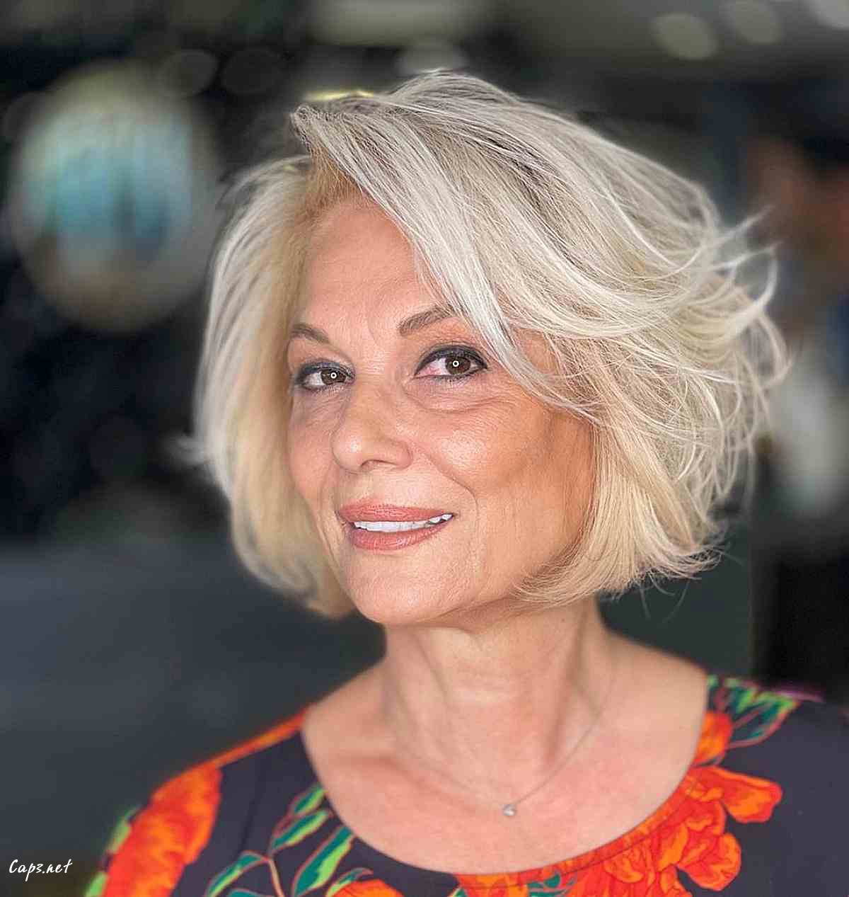 short feathered bob with a side part for women 60 and over