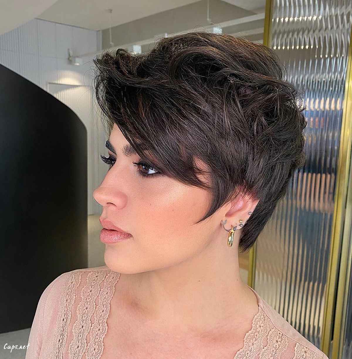modern shaggy pixie with long side swept bangs hairstyle