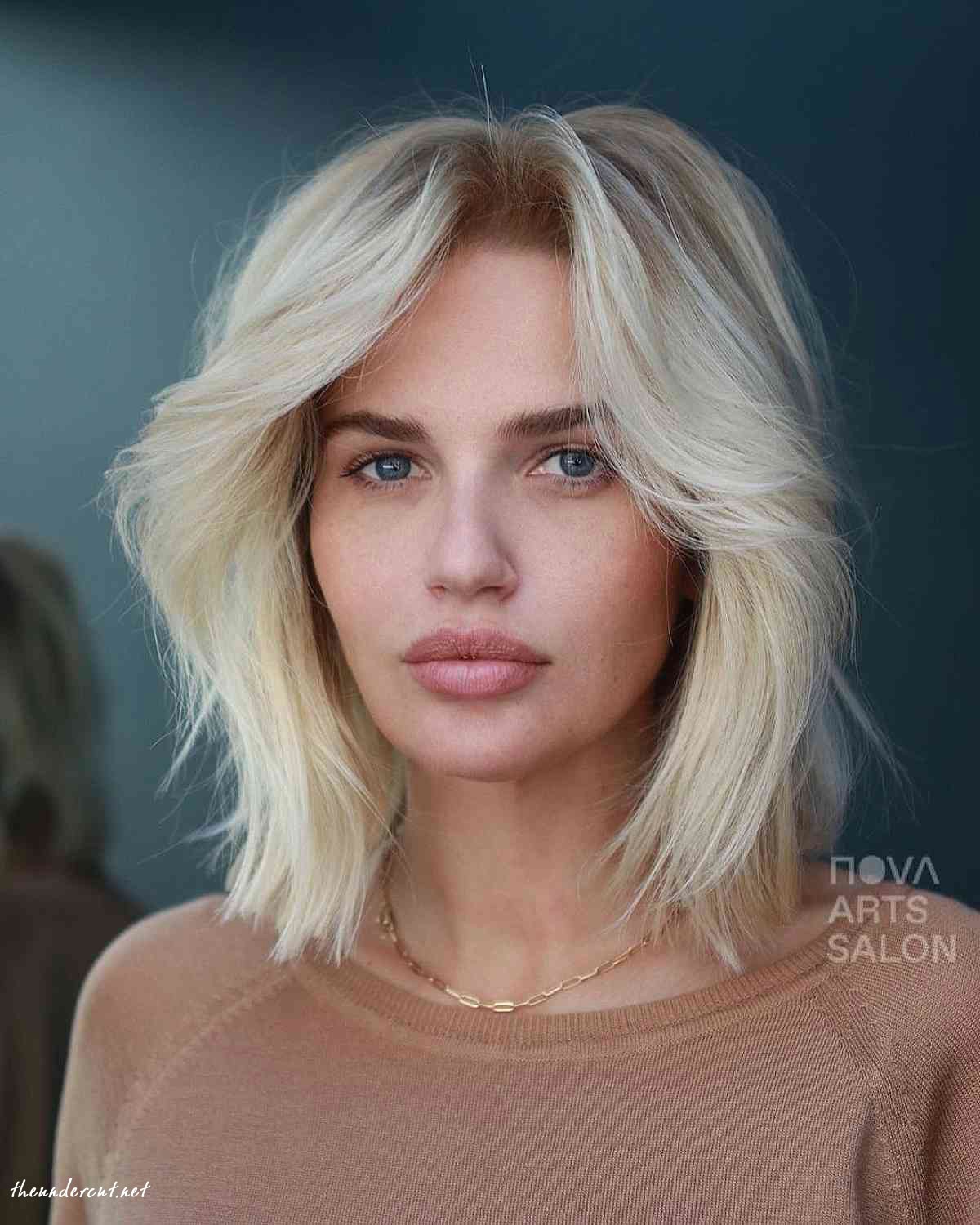 shaggy blonde bob with layers and curtain bangs