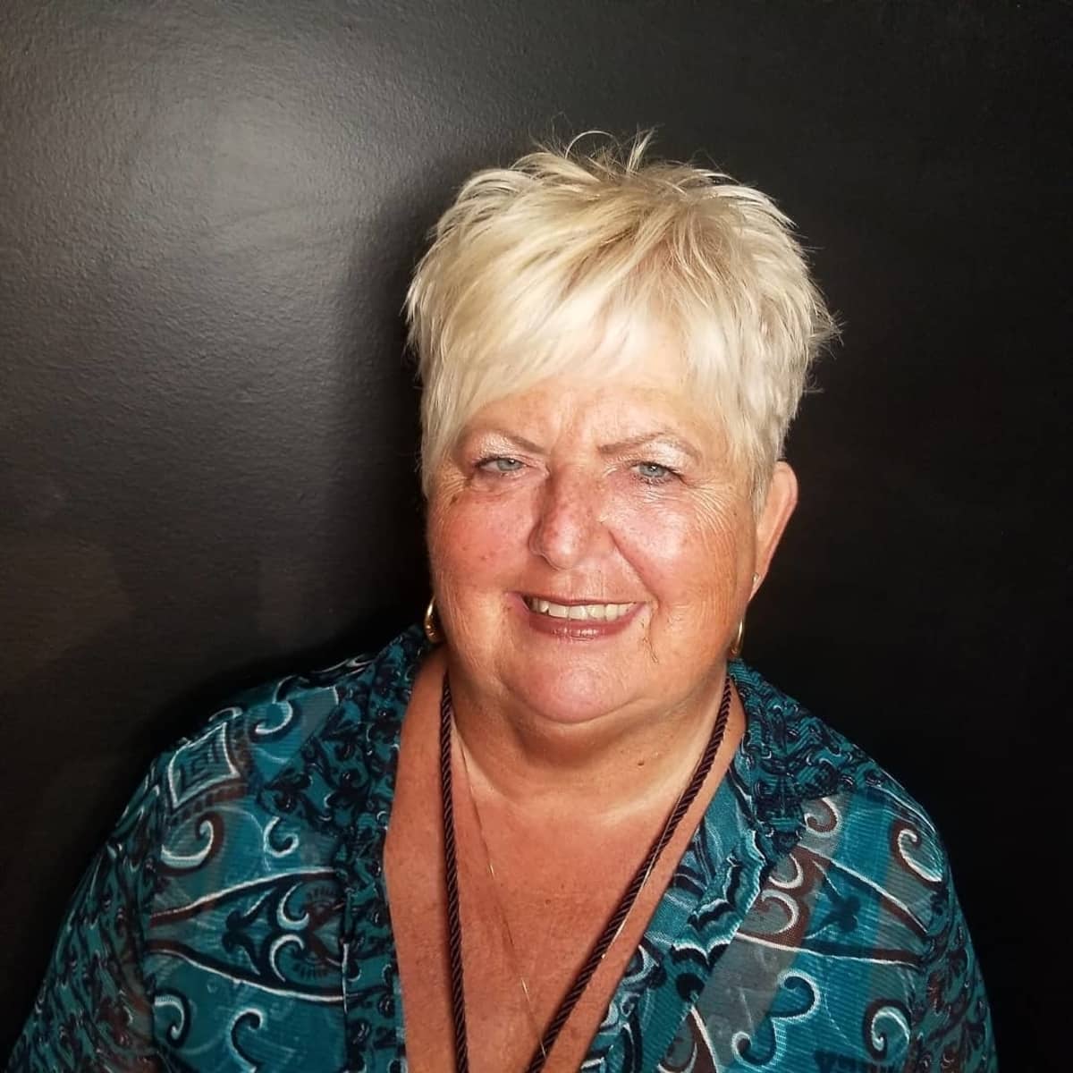 asymmetrical short cut thats messy and spiky for women over 60 with round faces