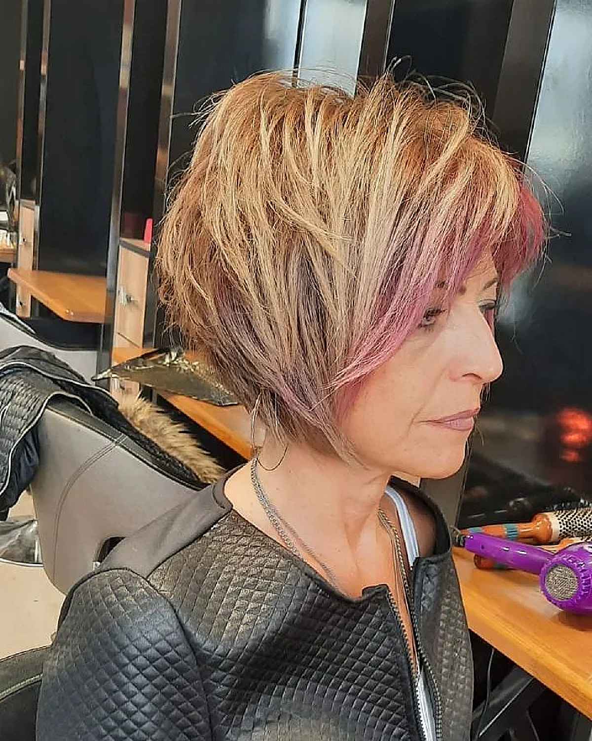 edgier short bob with lots of layering on a sixty year old woman