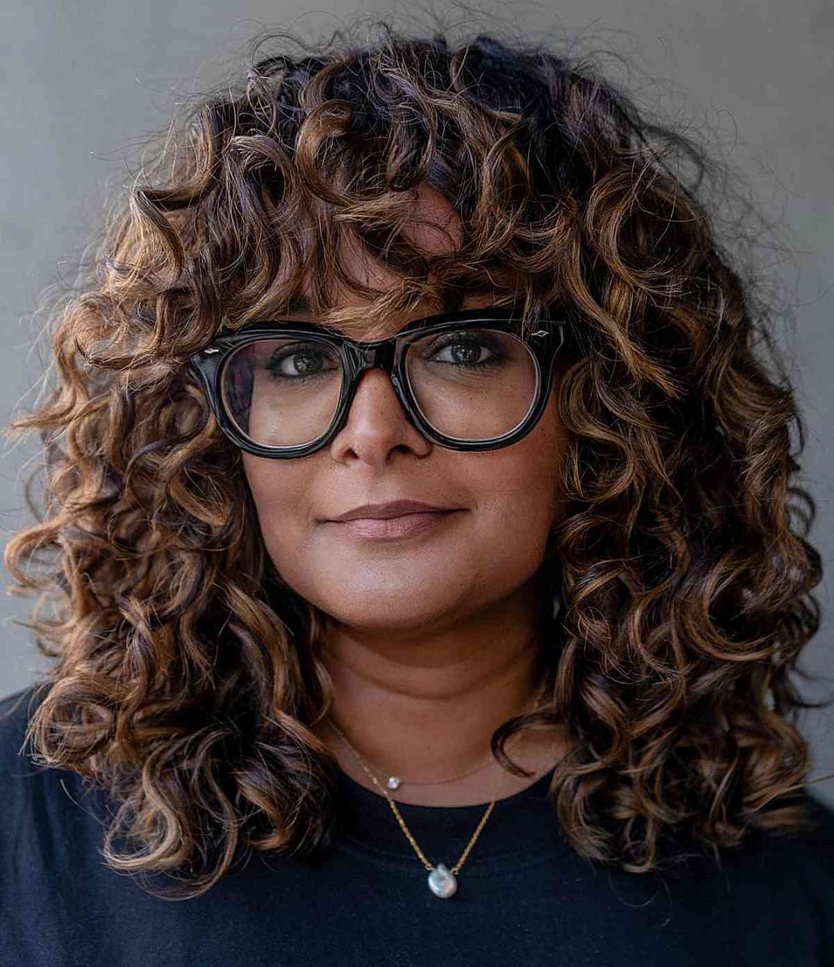 gorgeous thick dark curls with highlights for 40 year olds
