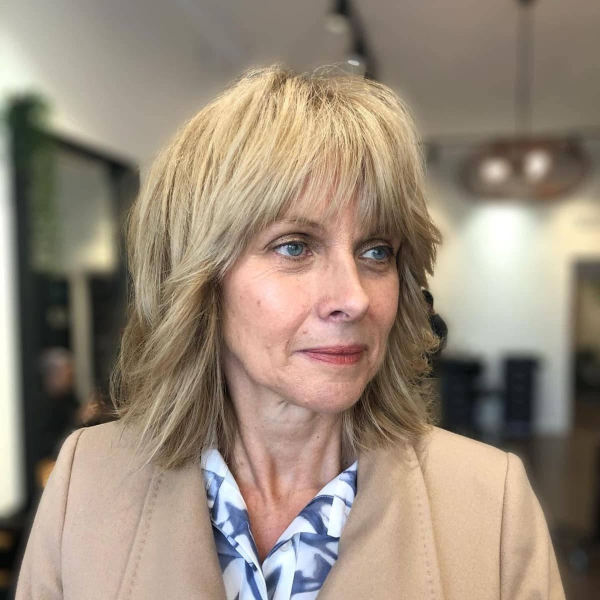 medium length hairstyle with bangs and layers for women over 60