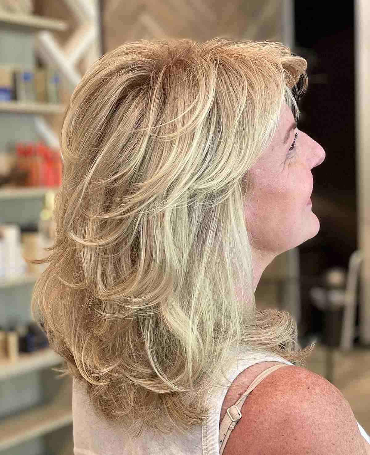 mid length blonde hair with feathered layers for women past their 40s