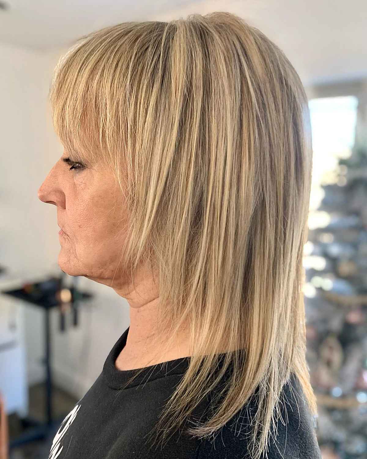 mid length straight shag with choppy bangs for women over 60