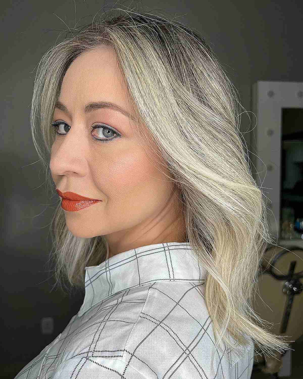 rooted blonde balayage on a medium haircut for ladies past 40