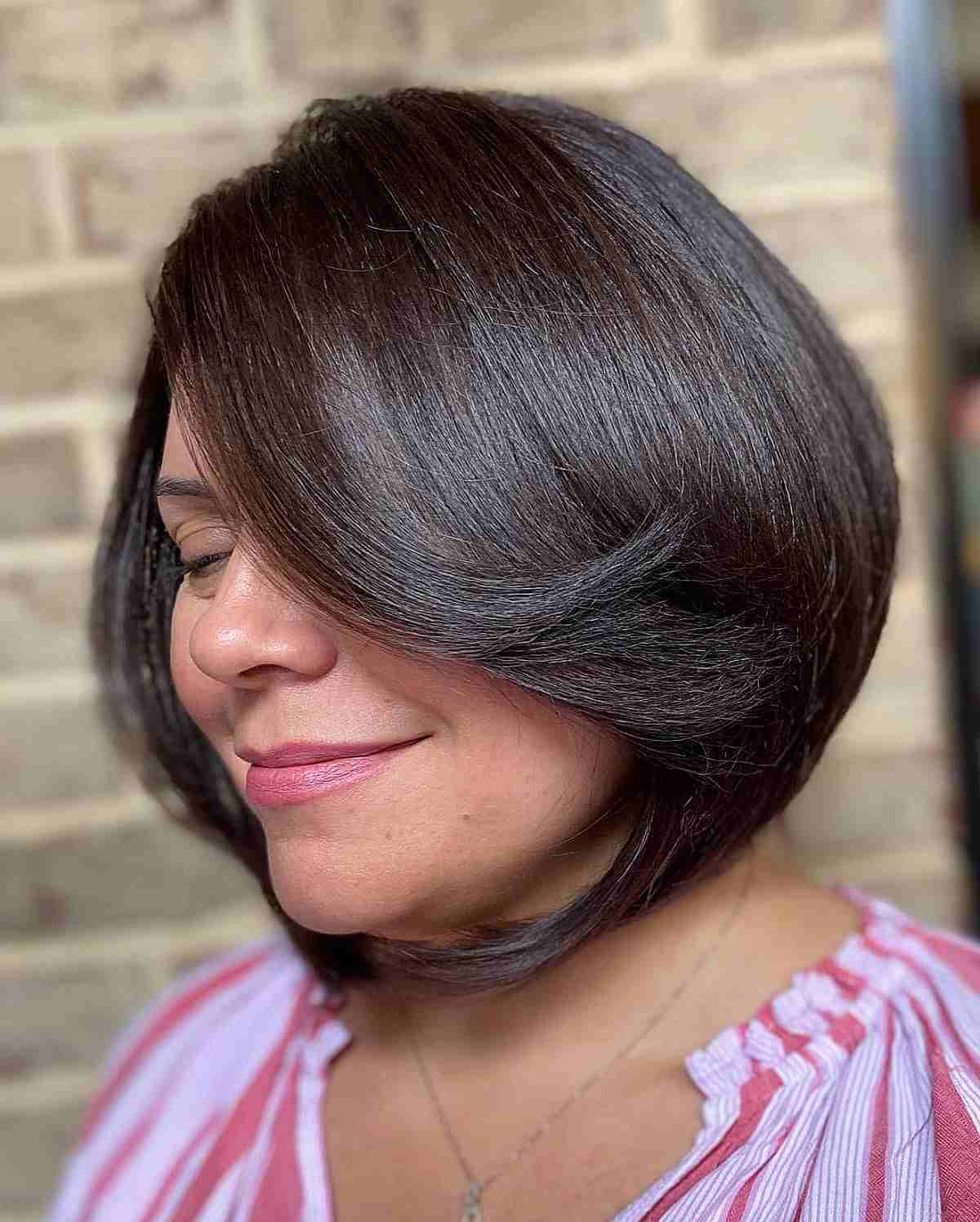rounded a line bob with long bangs for a lady in her 40s