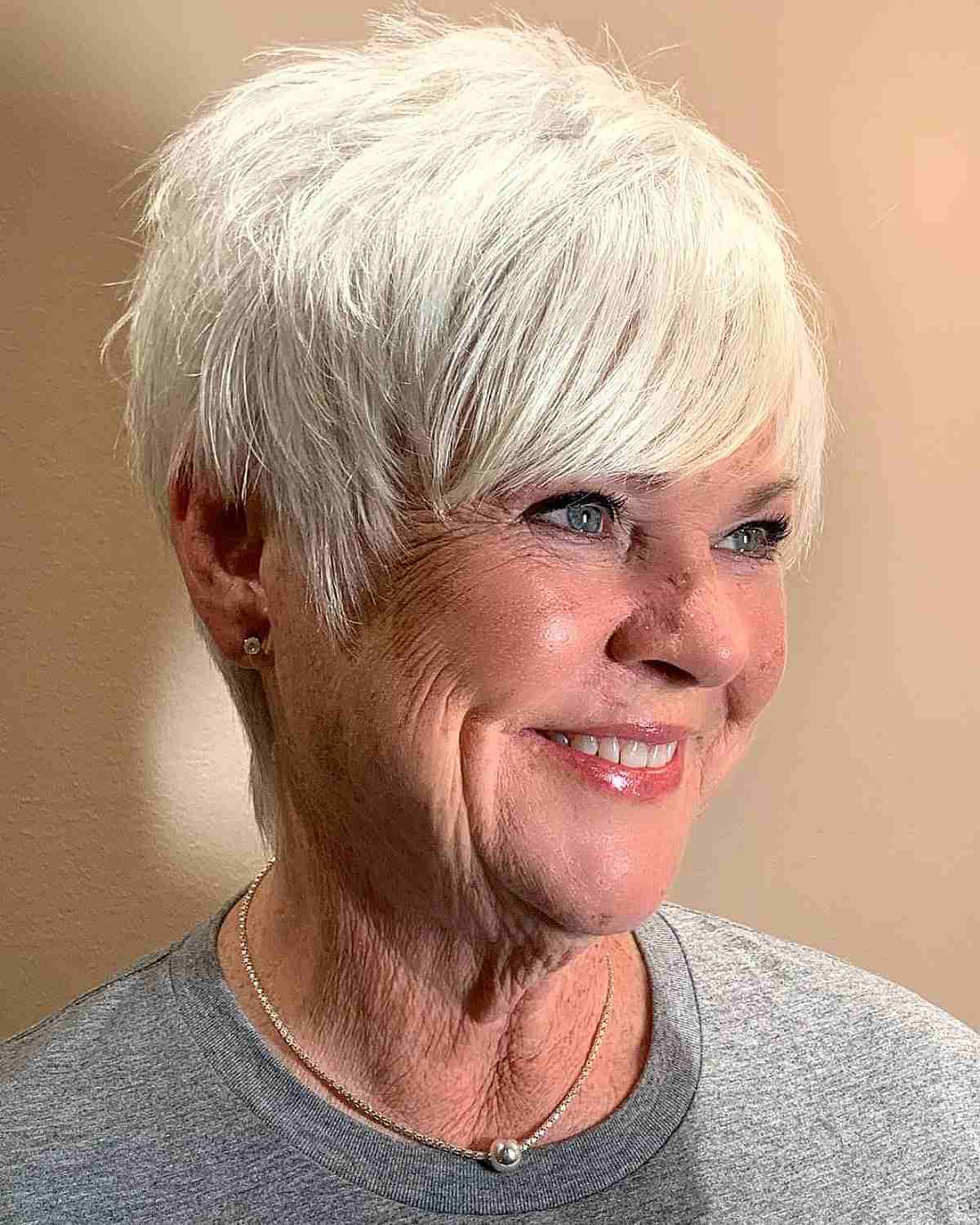 white blonde pixie with long bangs for women over 60 with thin hair
